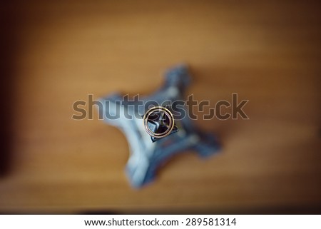 luxury amazing wedding ring on the souvenir statuette of an eiffel tower on background of wooden table