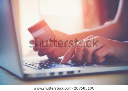 Hands holding credit card and using laptop. Online shopping Royalty-Free Stock Photo #289585190