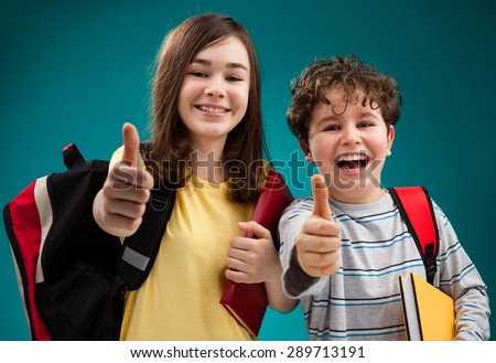 Students with backpack showing OK sign