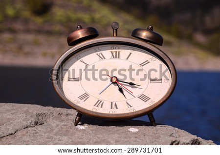 Time Concept Classic Vintage Pocket Clock on the Volcanic Rocks