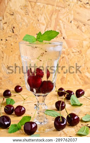 Cocktail with cherry and mint in a chilled glass
