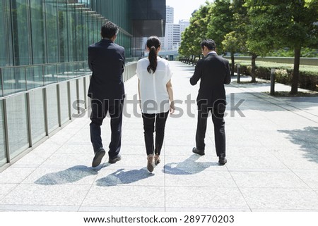 Rear view of multi-ethnic businesspeople walking