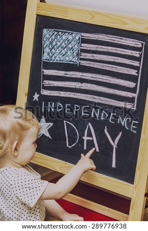 Figure child symbol of the independence day of America on the black drawing Board