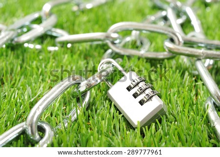 Silver key to dial-up. Iron chain, green background