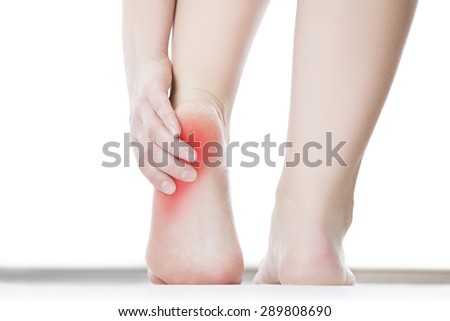 Pain in the foot. Massage of female feet. Pedicures. Isolated on white background. Royalty-Free Stock Photo #289808690