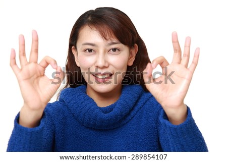 asian woman showing perfect sign