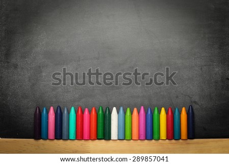 Still life, business, education concept. Black dusty chalkboard with crayons. Selective focus, copy space background, top view