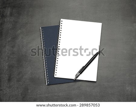 Still life, business, education concept. Office supplies, notepads and pen, on a chalkboard. Selective focus, copy space background, top view