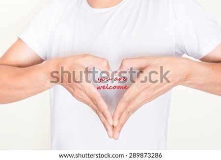 heart shape hands on left side chest of a man in white shirt with words - you are welcome