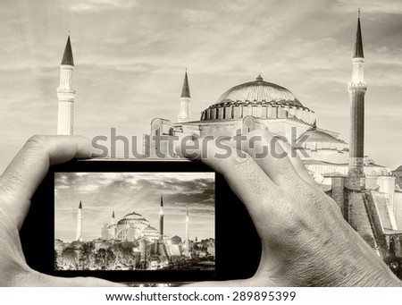 Man and woman hand capturing Hagia Sophia with smartphone.