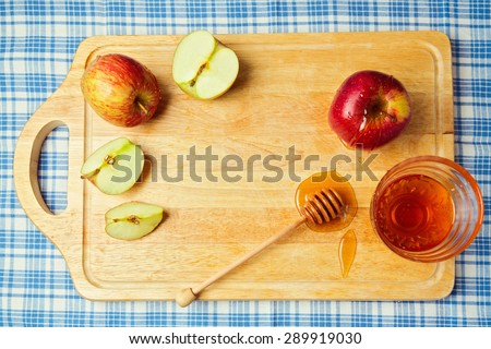 Apple and honey on wooden board. Jewish Rosh hashana (new year) celebration. View from above