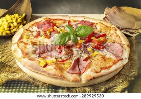 Retro effect photo filter. Pizza with ham, corn and pepper.