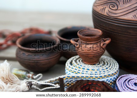 Ethnic ceramics and Ukrainian ethnic belt on a wooden background 