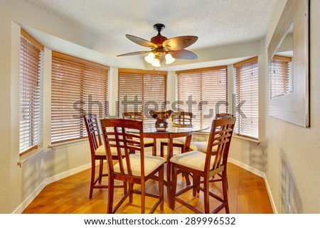 Elegant dinning room with hardwood floor and lots of windows.