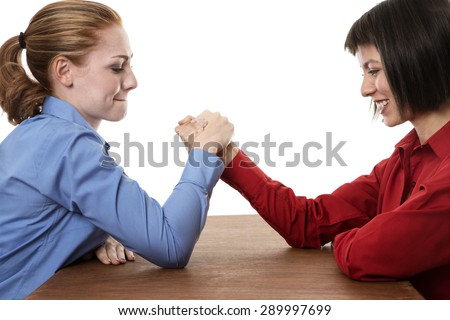 Two business women arm wrestling each other 