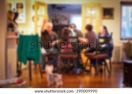 blurred image of Typical American family gathered around kitchen table Royalty-Free Stock Photo #290009990