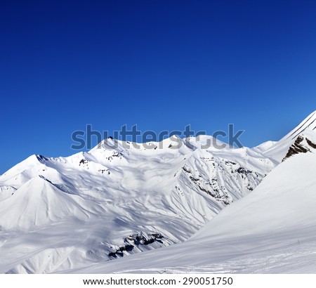 View on ski slope and beautiful mountains at sun day. Ski resort Gudauri. Caucasus Mountains, Georgia.