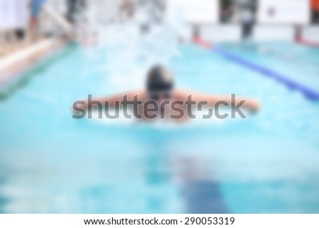 blurry background of boy swimming race