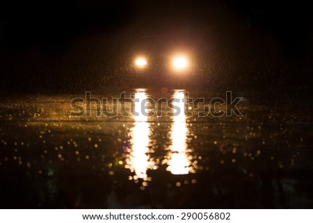 Yellow headlight and road in the dark while heavy raining. Royalty-Free Stock Photo #290056802