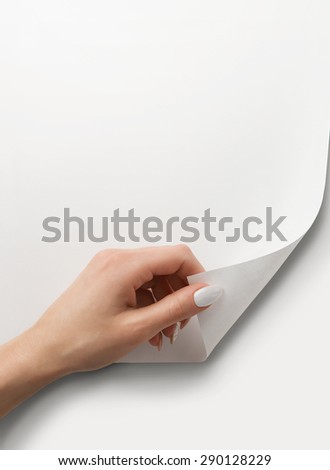 Close up of female hand turning the blank page with copy space