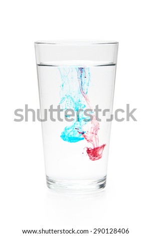 Blue and Red Color Dissolving in a Glass of Pure Water on White Background With Clipping Path