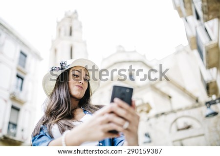 Woman taking self picture with smartphone camera
