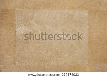 Light square on golden stone wall background.