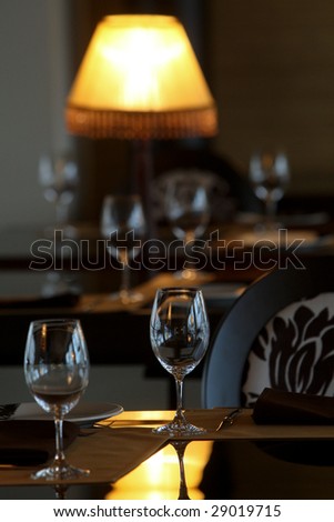 Empty wine glasses on tables in a restaurant interior