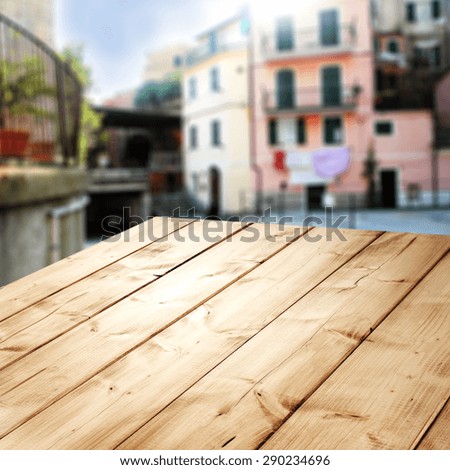 wooden old board place and blurred city of italy 