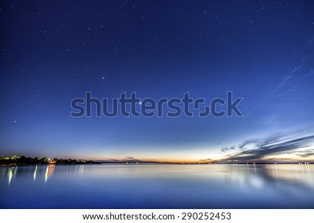 Beautiful sunset at dusk with stars above Royalty-Free Stock Photo #290252453