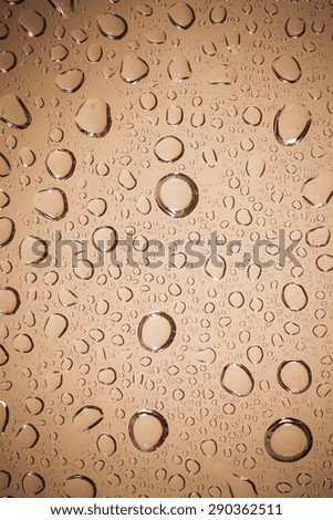 water drops on Brown glass background.