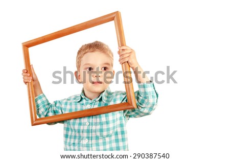 Happy kid holding a wooden picture frame on white background