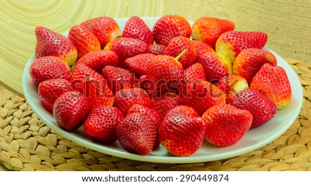 Fresh Strawberry on a Wooden Rustic Dish on a Braided Coaster/Fresh  Red Strawberries