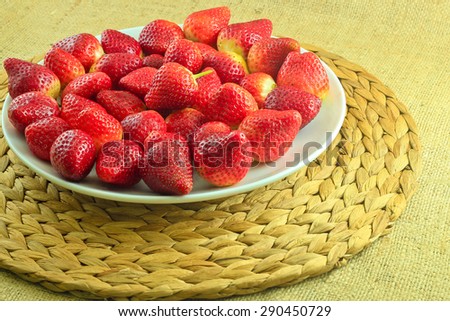 Fresh Strawberry on a Wooden Rustic Dish on a Braided Coaster/Fresh Red Strawberries
