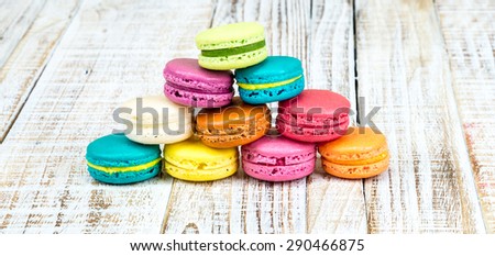 Colorful macarons on vintage pastel background. Macaron or Macaroon is sweet meringue-based confection. 
