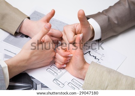 Image of human hands with their thumbs up symbolizing success in work