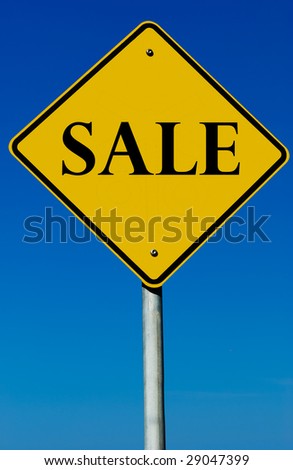 A sale sign isolated on a blue graduated sky.