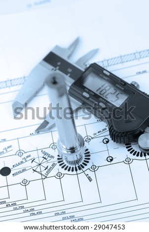 close up shot of a calliper with part on  Engineering drawing background