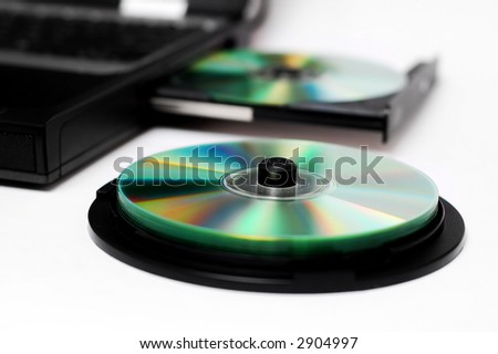 Isolated notebook with compact discs on a white background.