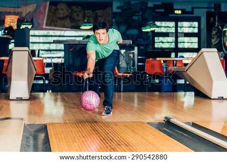young man plays bowling