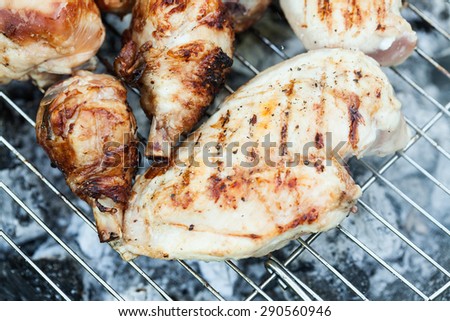 Chiken on the grill - paleo food photography with shallow depth of field. Royalty-Free Stock Photo #290560946