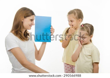 Mother shows two daughters plain color pictures, checking whether they distinguish colors