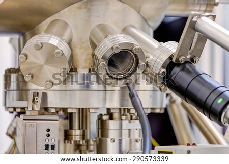 Detail of stainless steel machinery in physics laboratory Royalty-Free Stock Photo #290573339