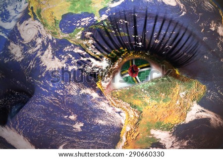 womans face with planet Earth texture and dominica flag inside the eye. Elements of this image furnished by NASA.