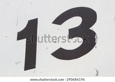 closeup black number 13 from traffic road sign in thailand, background