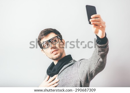 man photographing himself on the phone