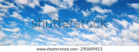 Panorama of a nice blue sky with fluffy white clouds, well suited as a background