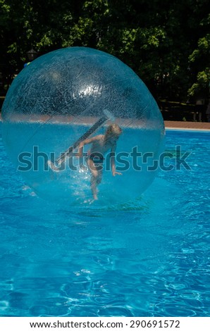 child in air bubble in swimming pool