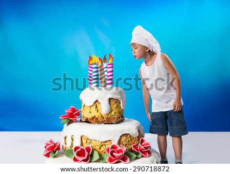Boy blows out the candles on the cake