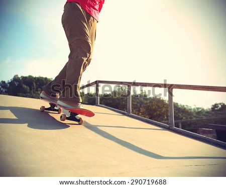 skateboarder legs skateboarding at skatepark ramp